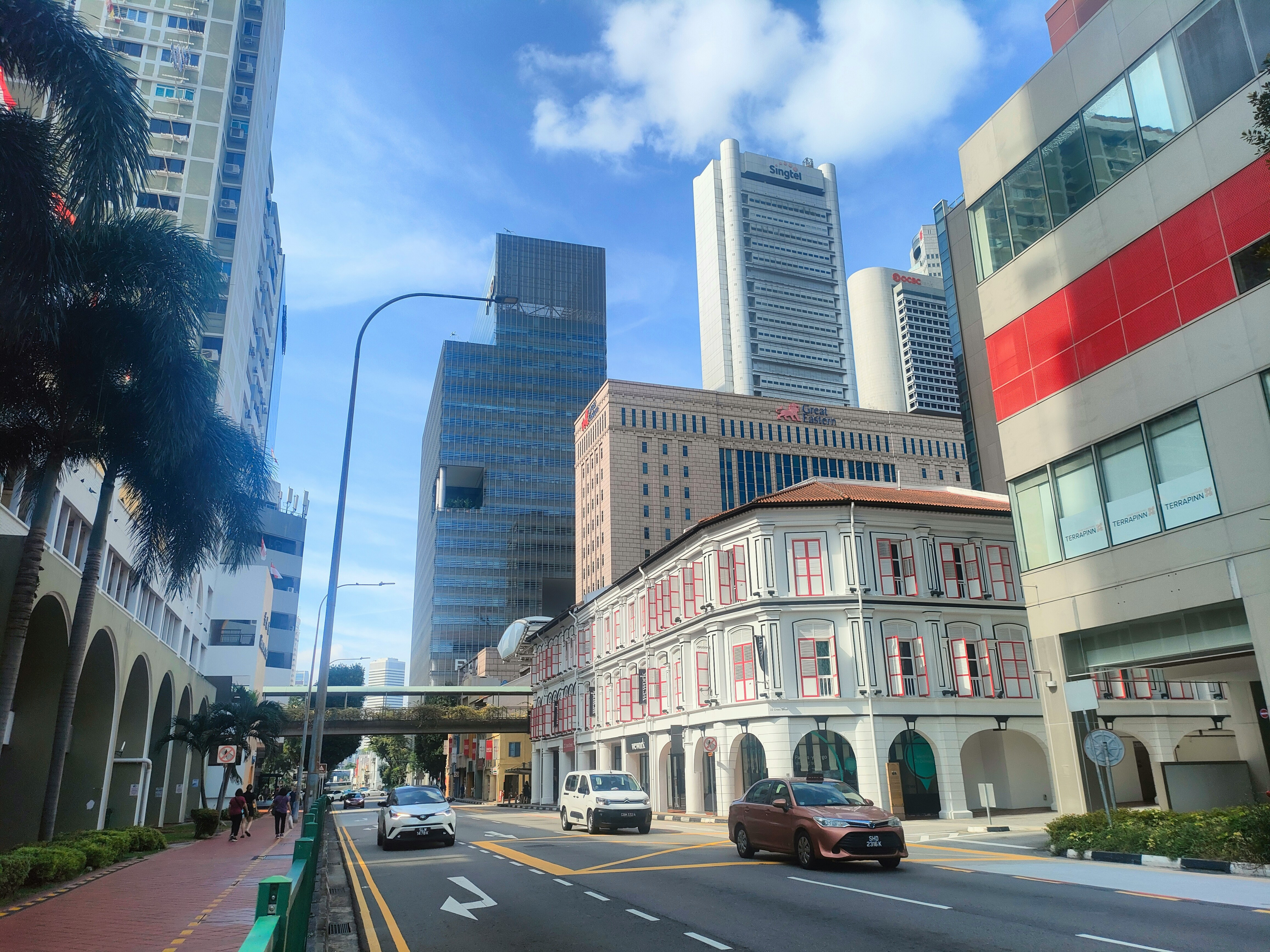 싱가포르의 현대적인 고층 빌딩과 저층 건물이 대비되는 거리 풍경. KSMC의 해외 거주자를 위한 상속 및 증여세 자문 서비스를 상징함.